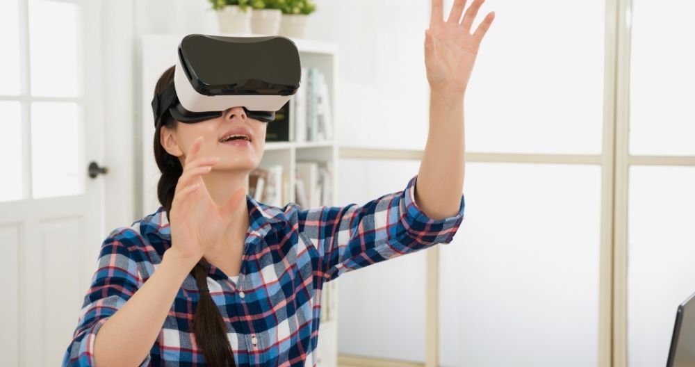 A woman wearing a VR headset, immersed in a virtual environment with swirling blue and white patterns surrounding them.