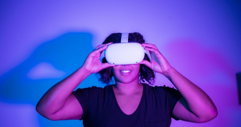 A woman wearing VR headset puting fingers on touchpad