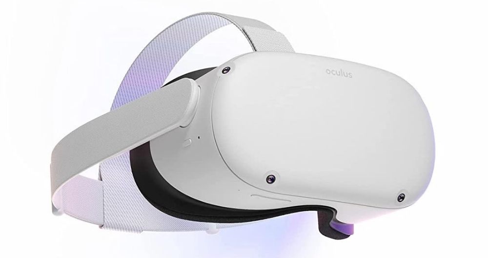 This is a white Oculus virtual reality headset with adjustable grey straps and black interior padding. The headset has several sensors or cameras embedded on the surface and the brand name “oculus” is visible on the side. The image background is plain white.